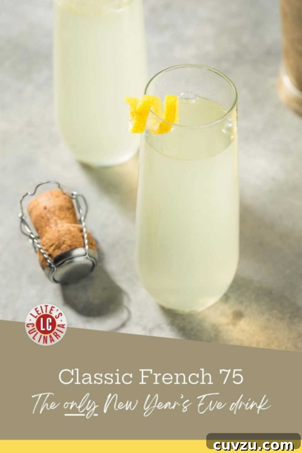 French 75 for a Party 3 Two stemless champagne flutes filled with a classic French 75 cocktail made with gin and lemon juice, garnished with lemon twists, sitting next to a champagne cork.