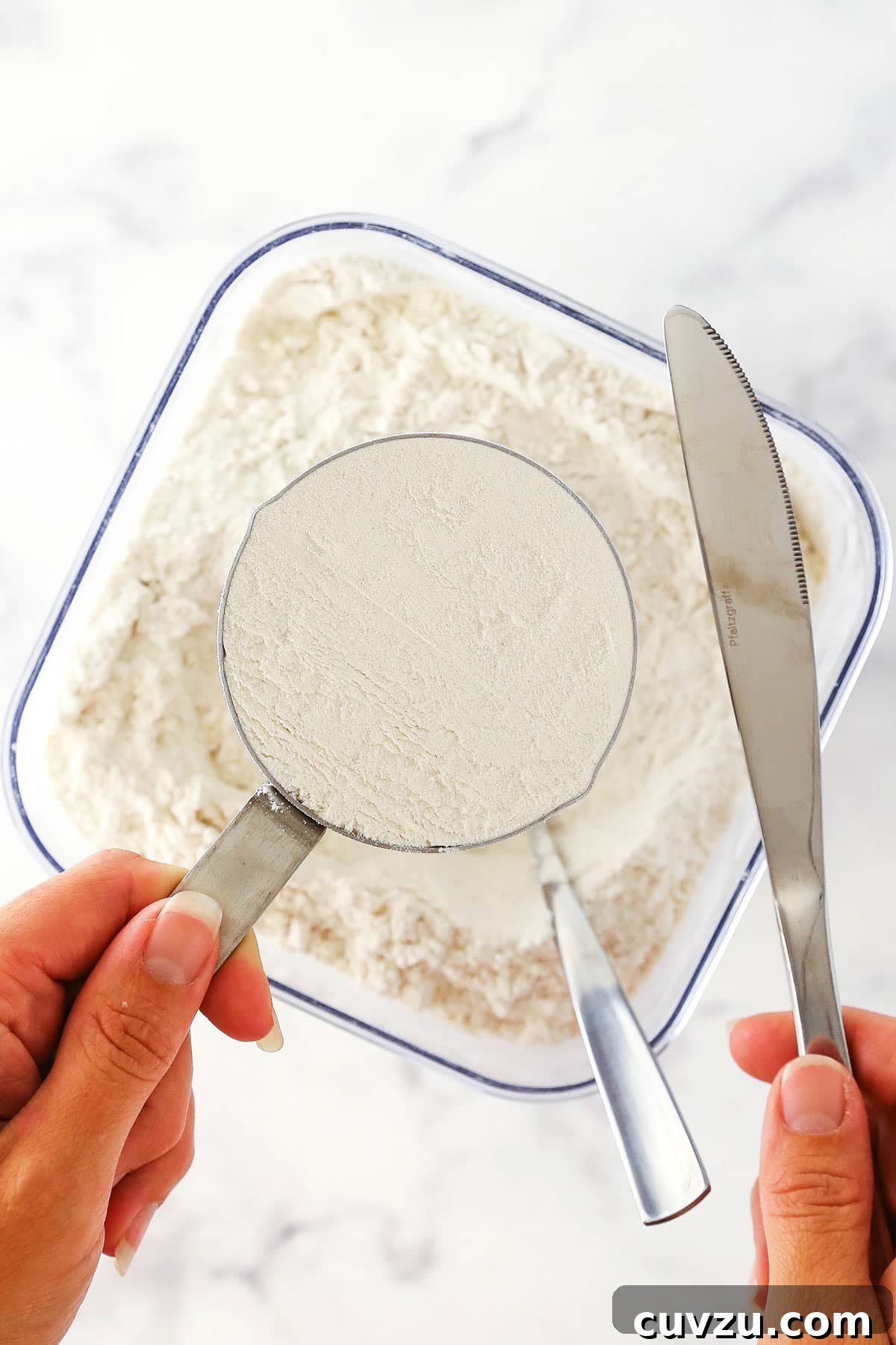 Flour Prepared for Baking with Precise Measurement A perfectly leveled cup of all-purpose flour, ready for use in a baking recipe after accurate measurement.