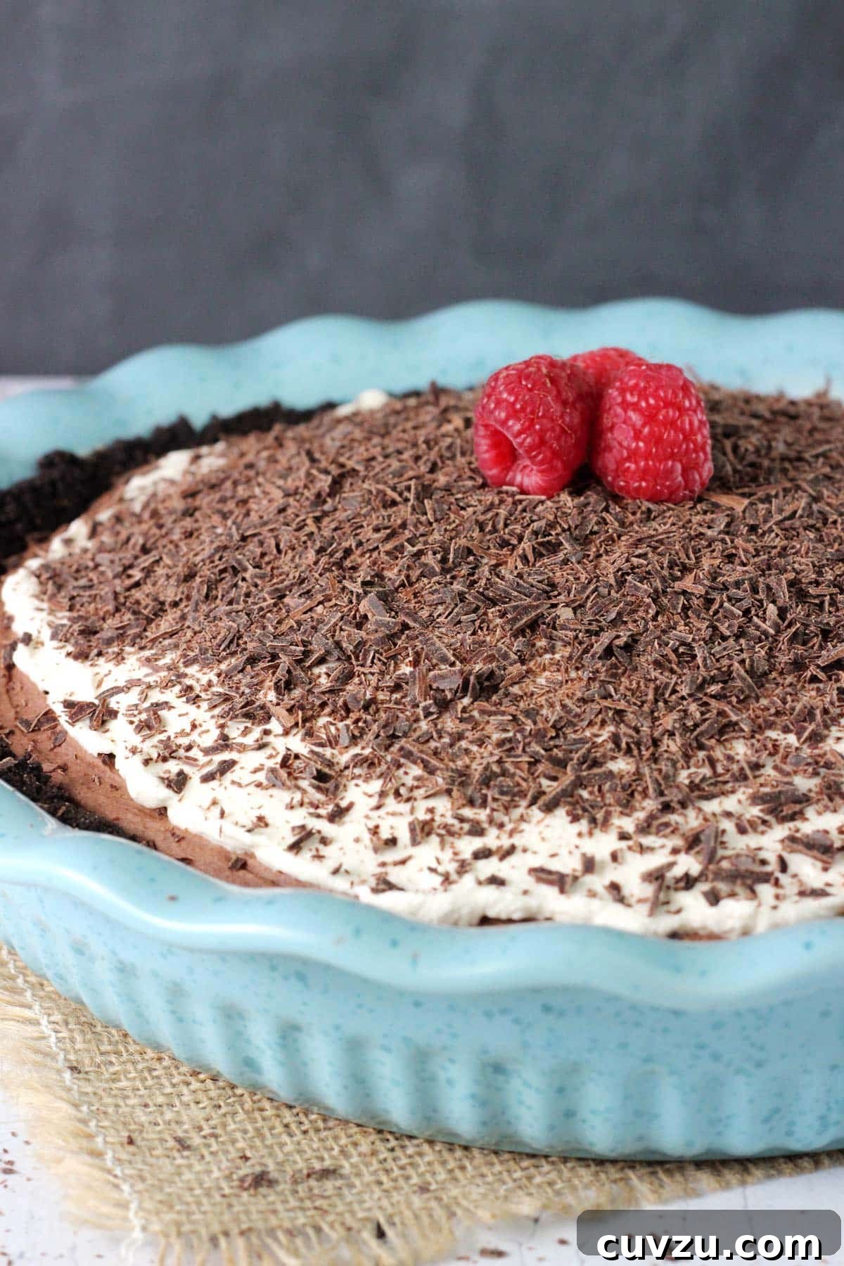 Decadent Chocolate Truffle Pie 6 Close up of a chocolate truffle pie in a blue ceramic pie pan.