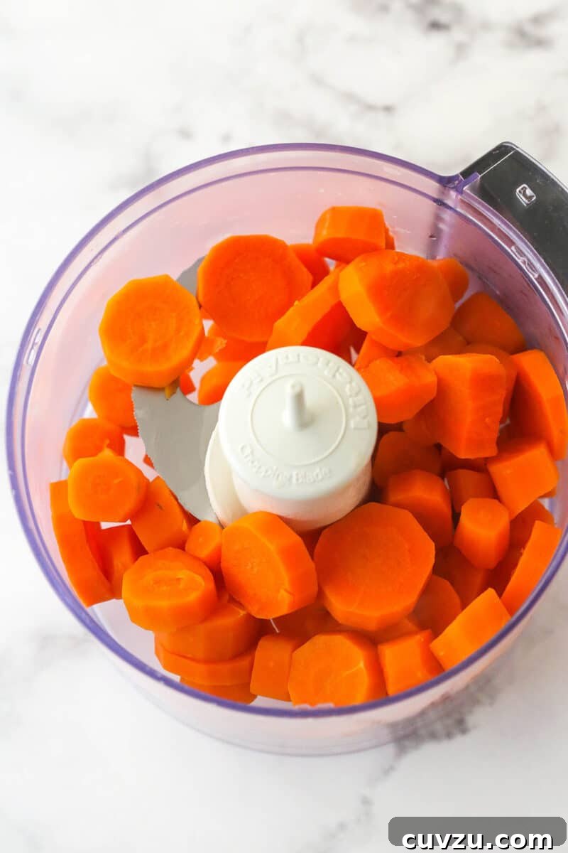 These moist carrot cake cupcakes are loaded with warm spices, teaming with exciting mix-ins, and topped with the best cream cheese frosting. Adding streamed carrots to a food processor.