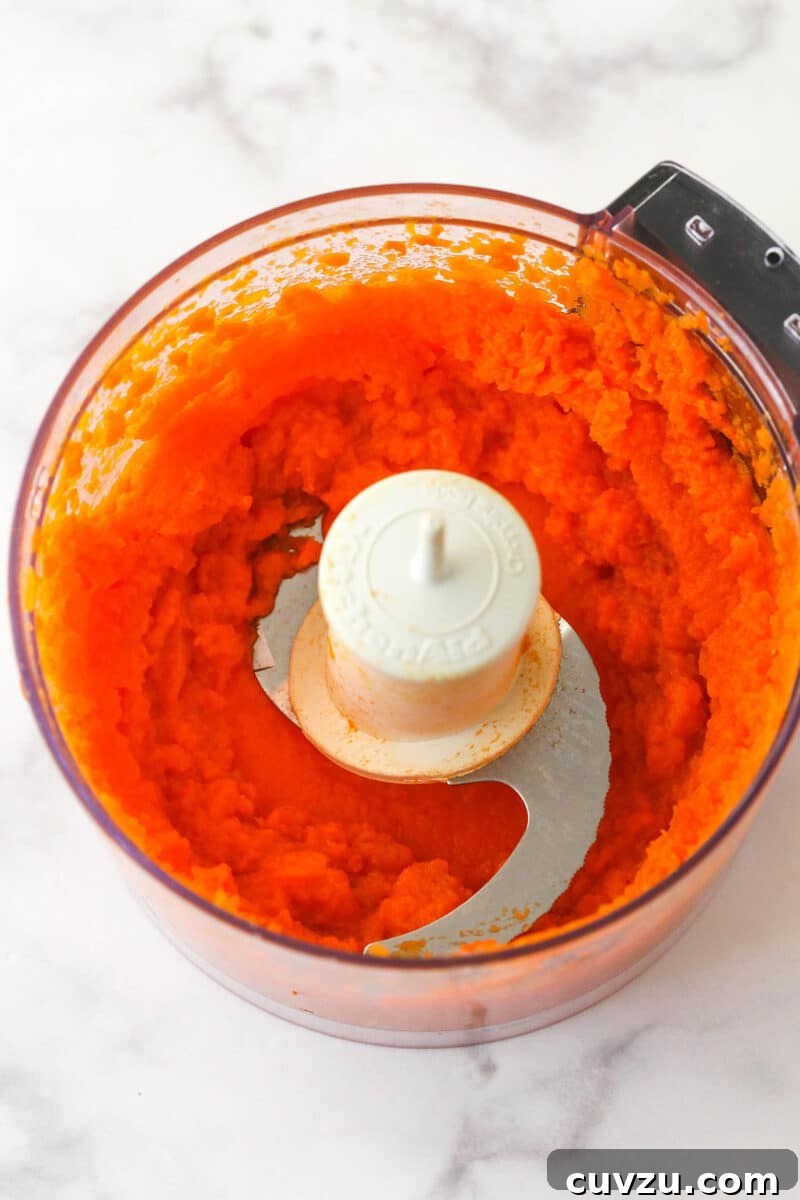 These moist carrot cake cupcakes are loaded with warm spices, teaming with exciting mix-ins, and topped with the best cream cheese frosting. Pureed carrots in a food processor.