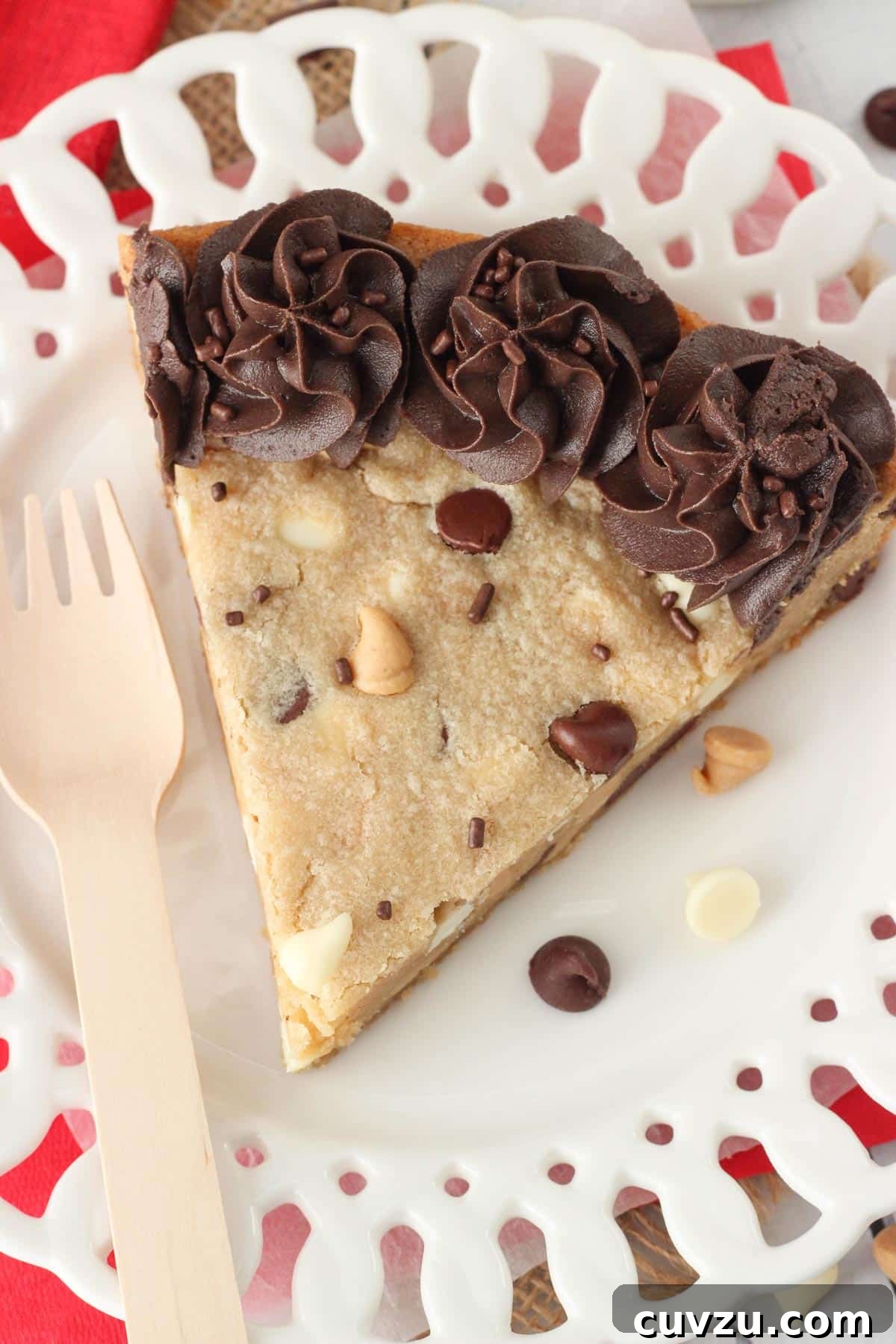 Ultimate Triple Chocolate Chip Cookie Cake 7 A top-down perspective of a single slice of Triple Chocolate Chip Cookie Cake on a white plate, emphasizing its uniform thickness and the beautiful blend of chips.