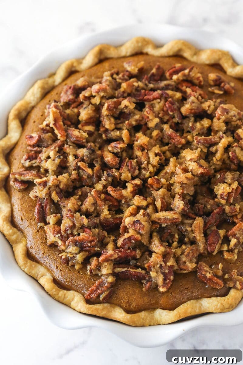 Caramelized Pecan Pumpkin Pie 10 Overhead view of the pecan praline topping generously crumbled over the pumpkin pie before its final bake.