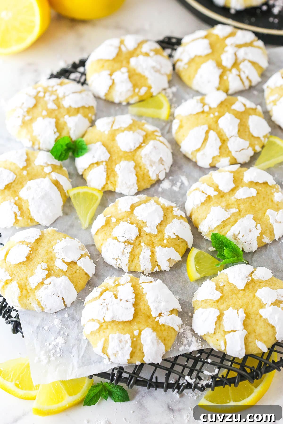 A stunning overhead shot of perfectly baked Lemon Crinkle Cookies, showcasing their beautiful crackled tops on a cooling rack. An overhead view of a batch of freshly baked lemon crinkle cookies cooling on a wire rack, showing their delightful crackle texture.