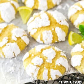 Bright and tangy lemon crinkle cookies displayed on a cooling rack, featuring their signature powdered sugar cracks.
