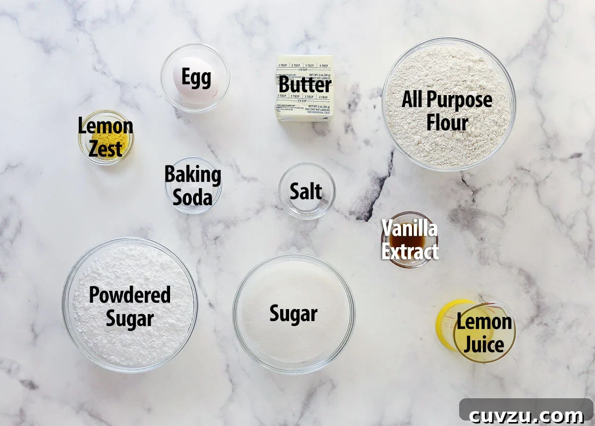 Discover the simple yet essential ingredients that create these flavorful Lemon Crinkle Cookies, enhanced by fresh lemon juice and zest and a beautiful powdered sugar finish. Luminously arranged ingredients for lemon crinkle cookies, clearly labeled for easy identification and preparation.