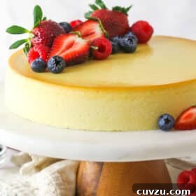 Ricotta cheesecake on a serving platter topped with fresh fruit