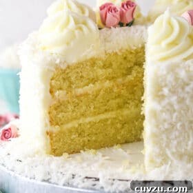Tropical Delight Cake 18 coconut cake with a slice removed to see the inside