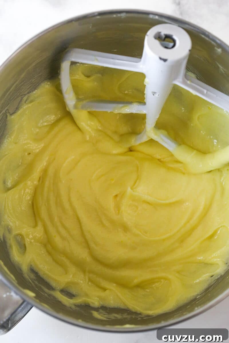 Tropical Delight Cake 8 Cake batter in a mixing bowl after the eggs have been incorporated, showing a smooth, cohesive mixture.