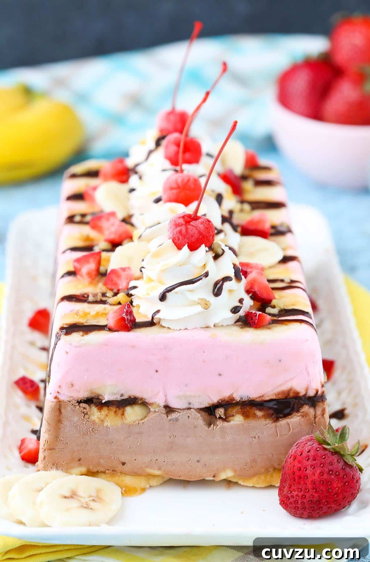 Frozen Banana Split Loaf 5 The full banana split ice cream cake loaf rests on a white tray, showcasing its elegant presentation and tempting layers, ready for enjoyment.