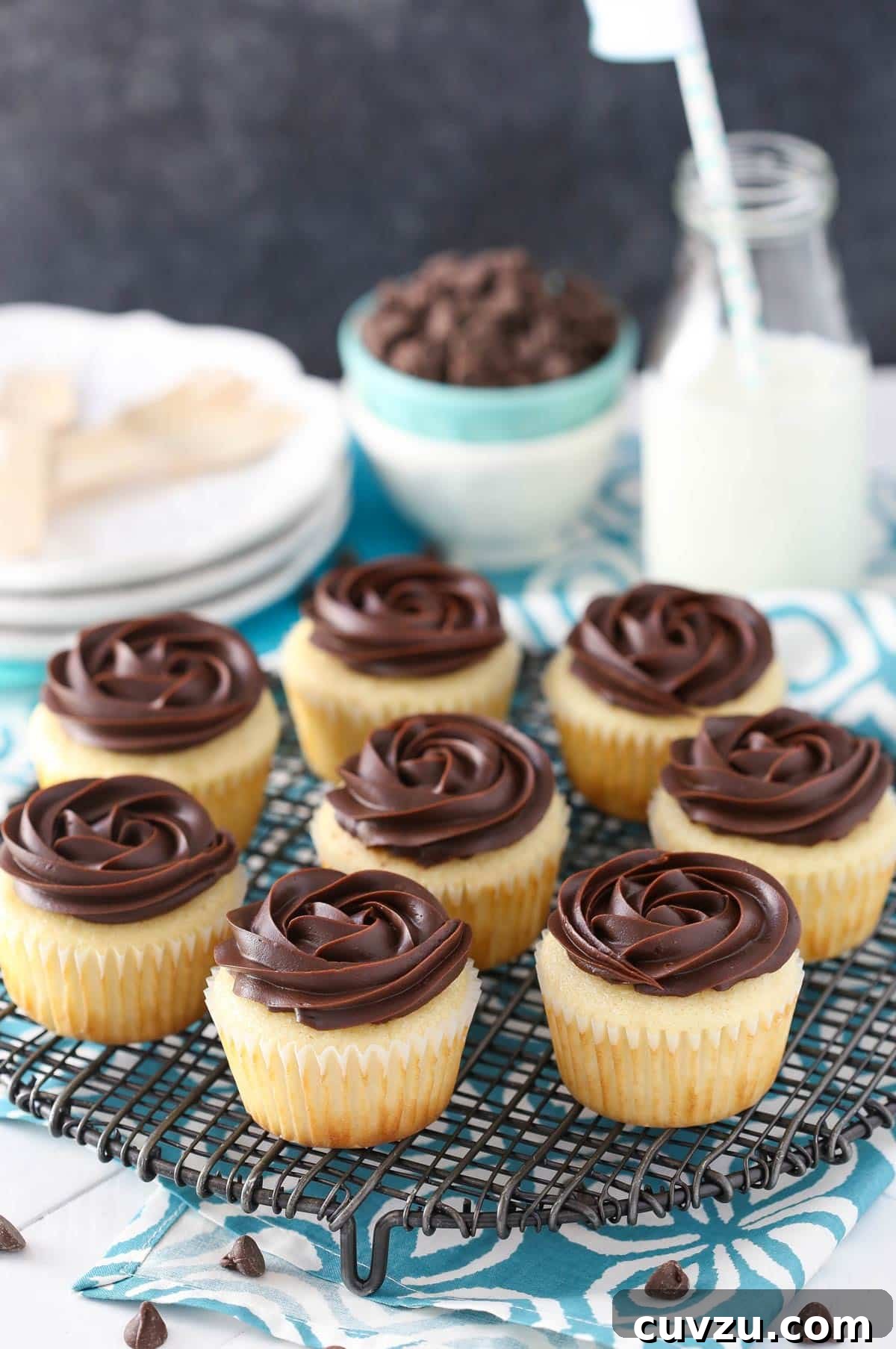 Decadent Boston Cream Cupcakes 8 An array of Boston cream pie cupcakes cooling on a wire rack.
