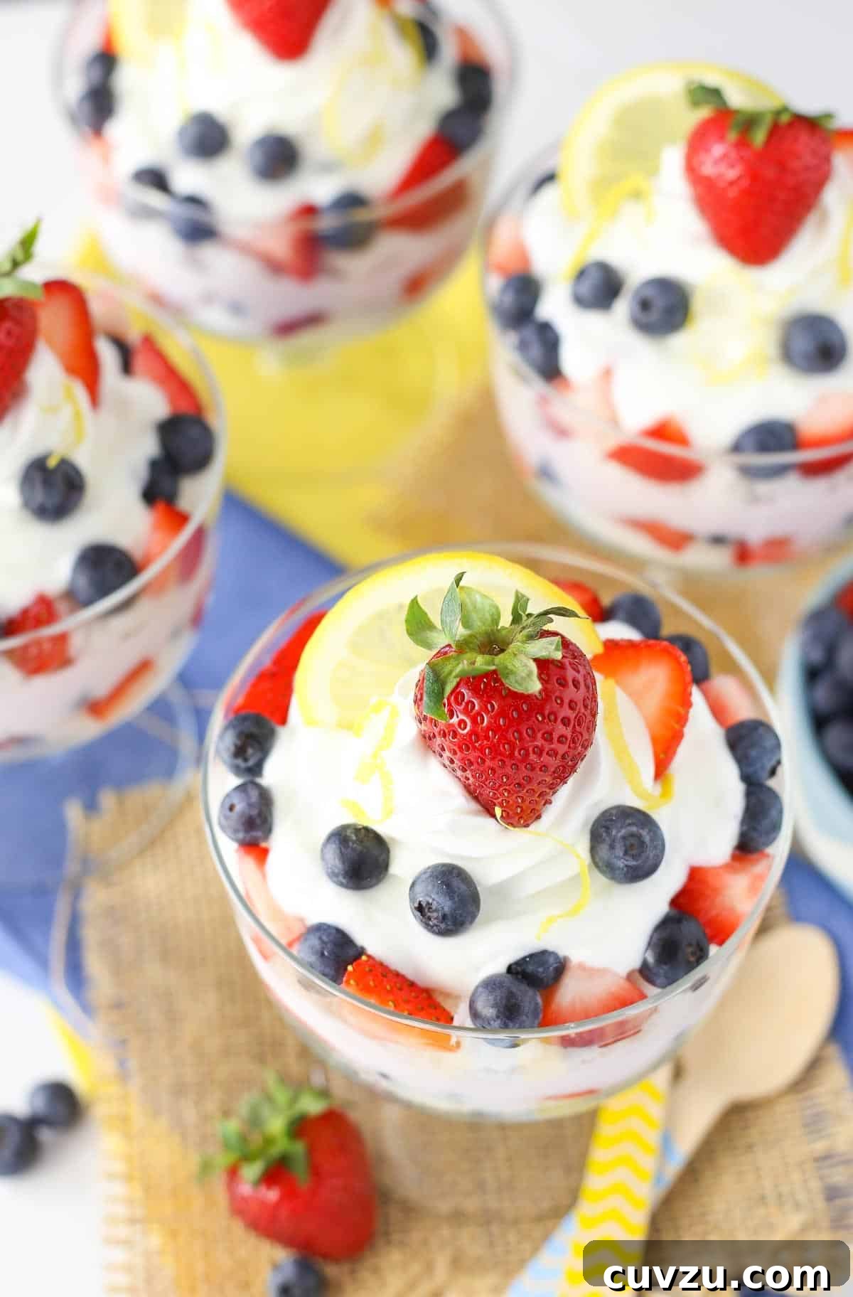 Tangy Berry Bliss Layers 3 Overhead shot of a single lemon berry yogurt trifle garnished with a lemon slice and fresh berries, ready to be enjoyed.
