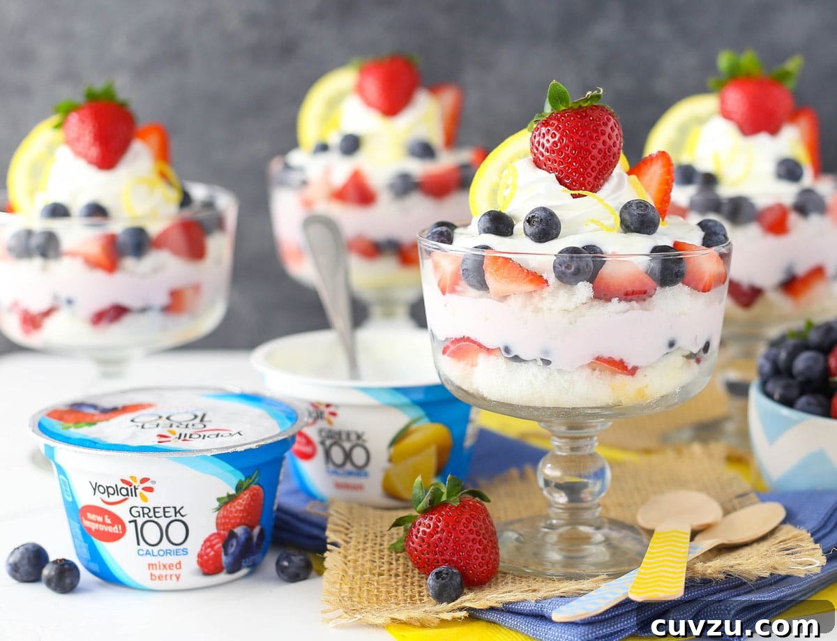 Tangy Berry Bliss Layers 4 Two containers of Yoplait Greek 100 yogurt (lemon and mixed berry) placed next to a finished lemon berry yogurt trifle, highlighting the key ingredients.