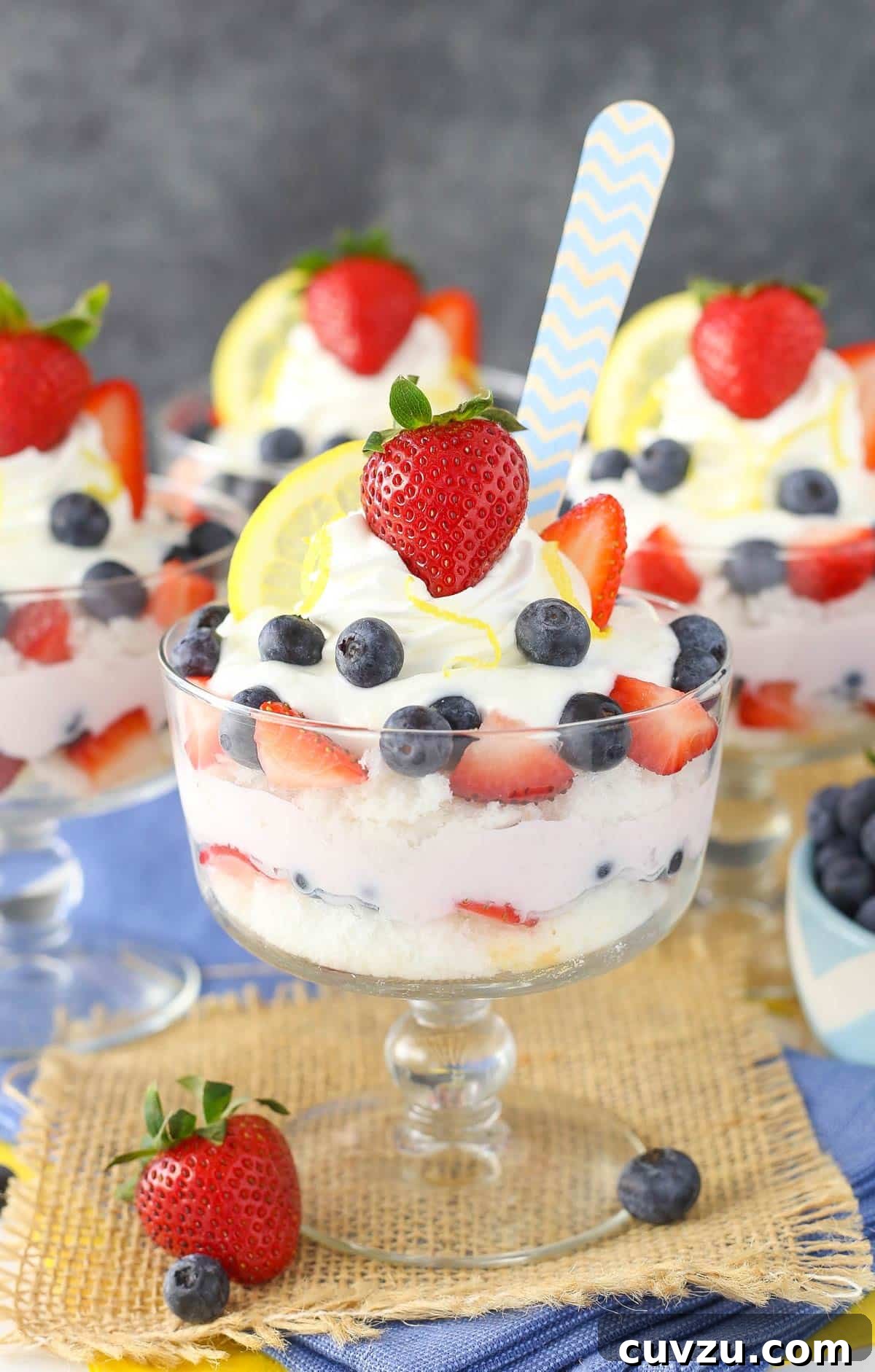 Tangy Berry Bliss Layers 5 A close-up shot of a lemon berry yogurt trifle with a spoon, showing the rich, layered texture and fresh fruit.