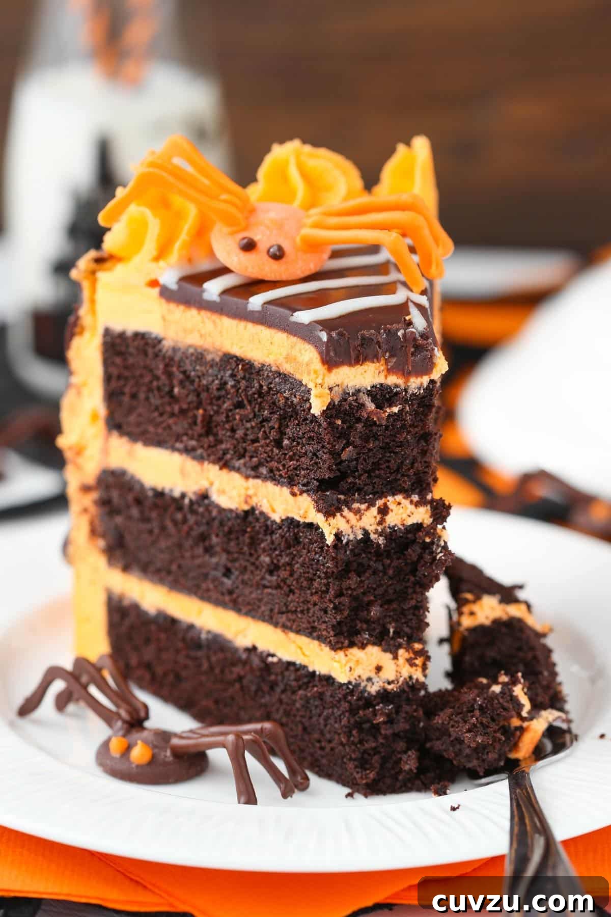 Haunted Web Chocolate Cake with Silky Vanilla Glaze 9 A slice of spiderweb chocolate cake with a bite taken out, on a fork, ready to be enjoyed.