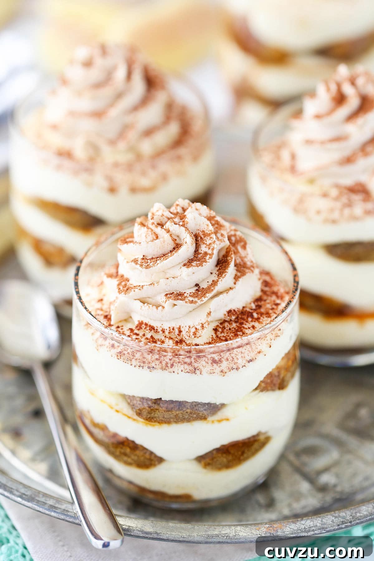 Tiramisu Bites 4 A close-up shot of a group of three tiramisu trifles on a serving platter