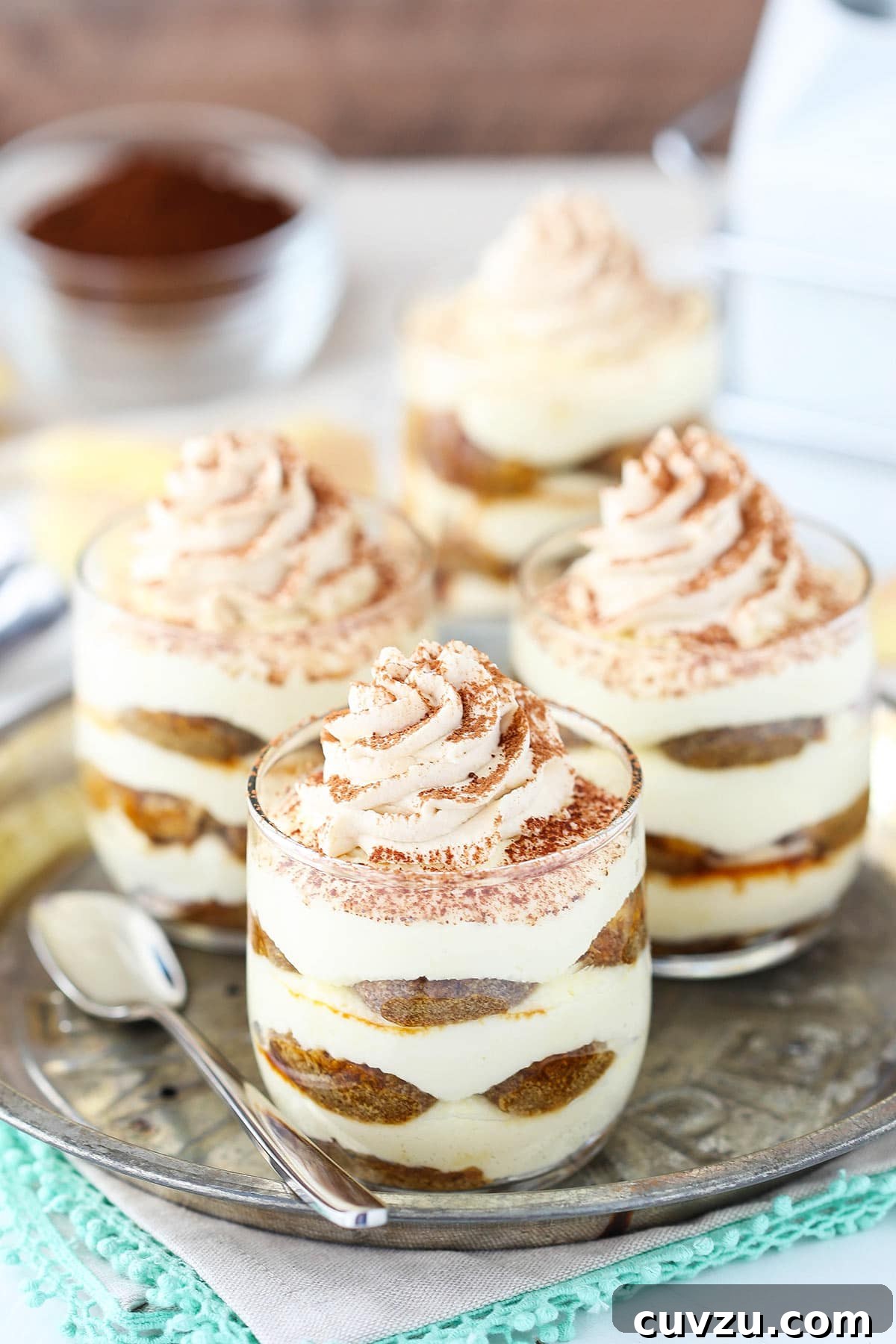 Tiramisu Bites 5 A tray holding three mini trifles and a metal spoon with a long stem