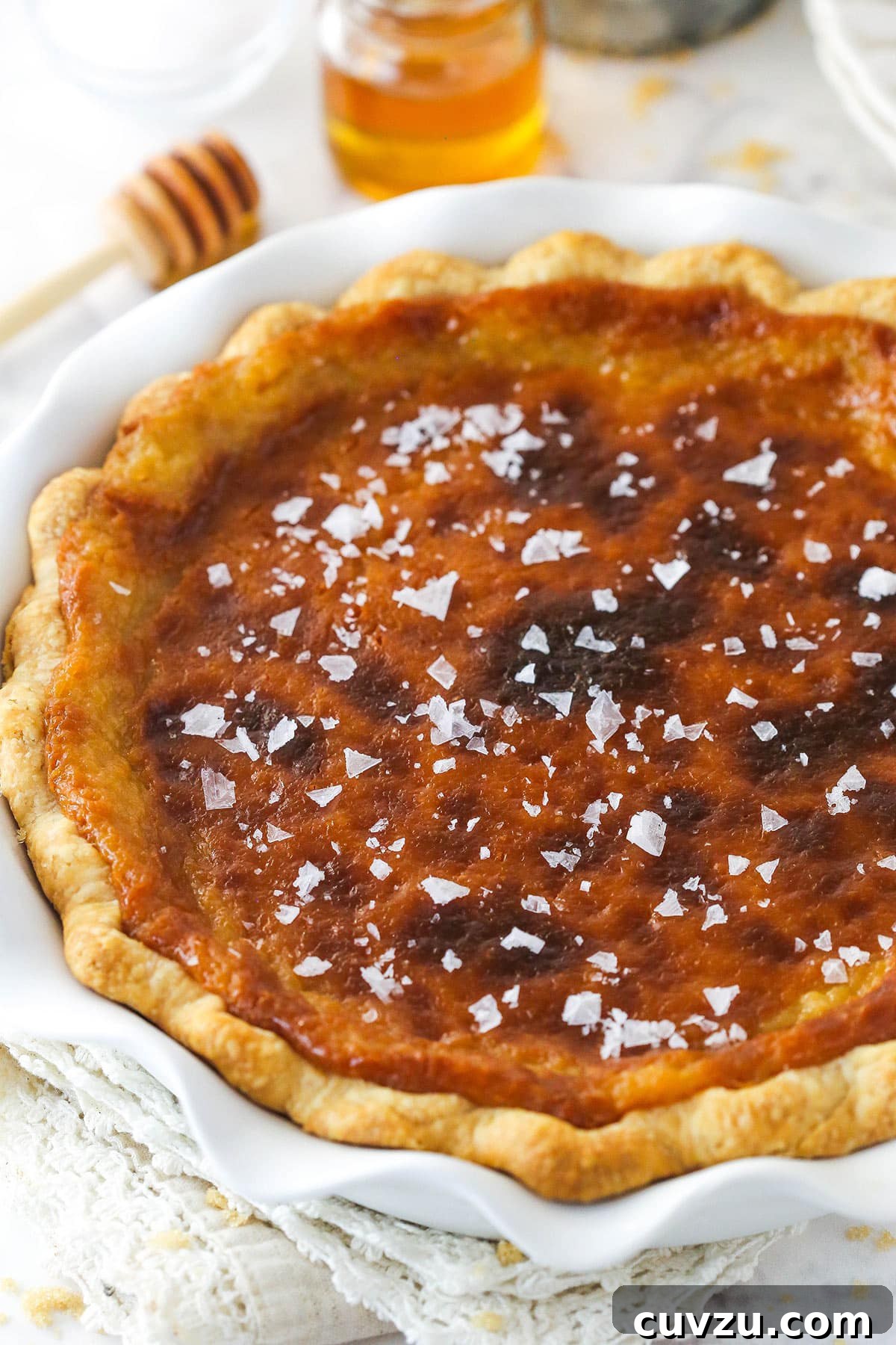 Perfectly salty and sweet, this Salted Honey Pie features a creamy custard-based filling in a classic butter pie crust. Sea salt sprinkled on honey pie