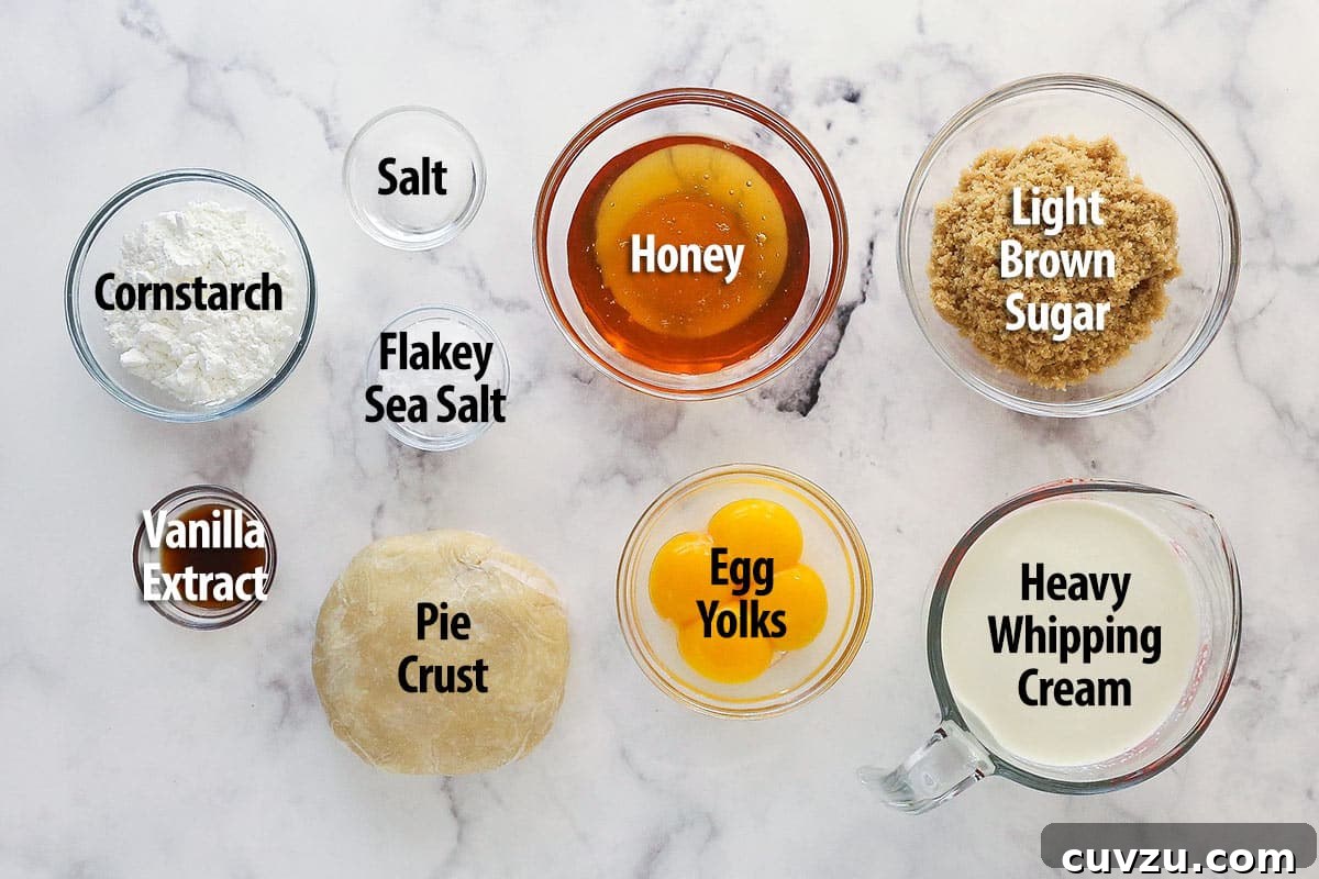 Perfectly salty and sweet, this Salted Honey Pie features a creamy custard-based filling in a classic butter pie crust. Overhead view of ingredients needed to make salted honey pie