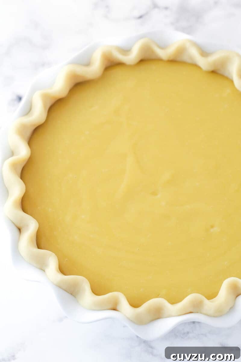 Perfectly salty and sweet, this Salted Honey Pie features a creamy custard-based filling in a classic butter pie crust. Honey custard filling in a pie crust