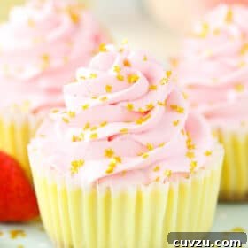 A close-up shot of a mini champagne cheesecake garnished with shiny gold star sprinkles, emphasizing its festive appeal.
