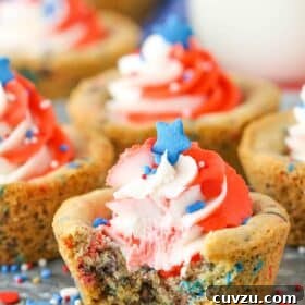 Close up of a patriotic chocolate chip cookie cup with a bite out of it.