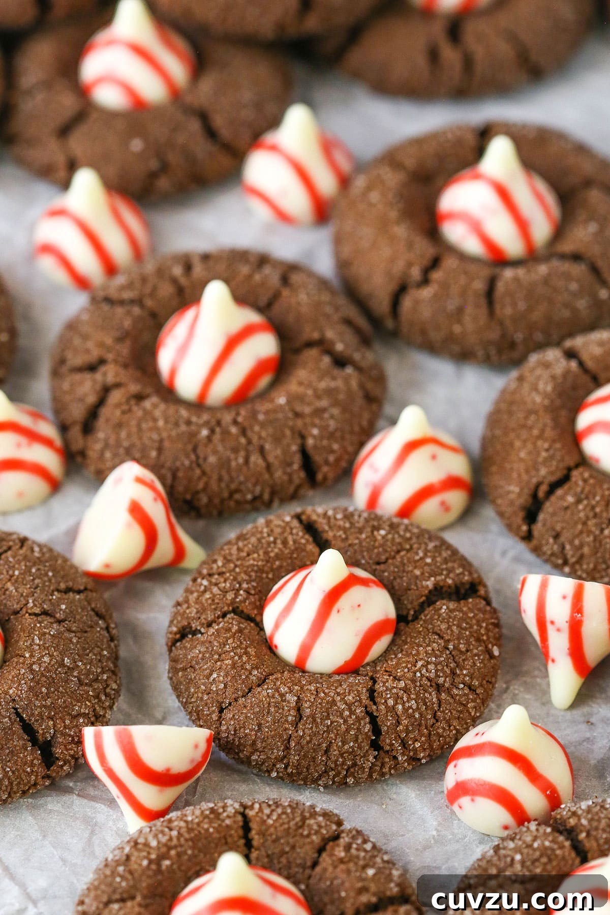 Soft and chewy Peppermint Chocolate Thumbprint Cookies, a perfect Christmas treat. A tray of freshly baked Peppermint Chocolate Thumbprint Cookies cooling on parchment paper, ready for holiday festivities.