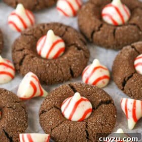 Peppermint Chocolate Thumbprint Cookies spread evenly over parchment paper
