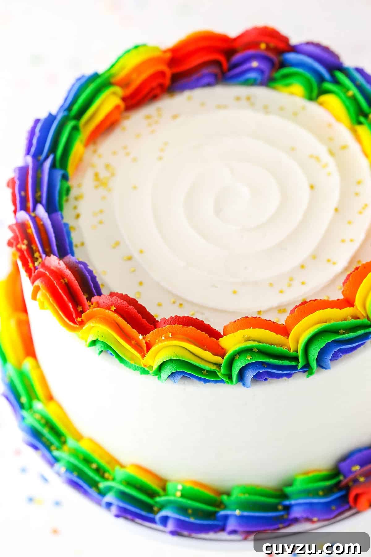 Kaleidoscope Cake 8 An overhead view of the completed Rainbow Swirl Cake, showcasing its vibrant layers and intricate frosting pattern from above.