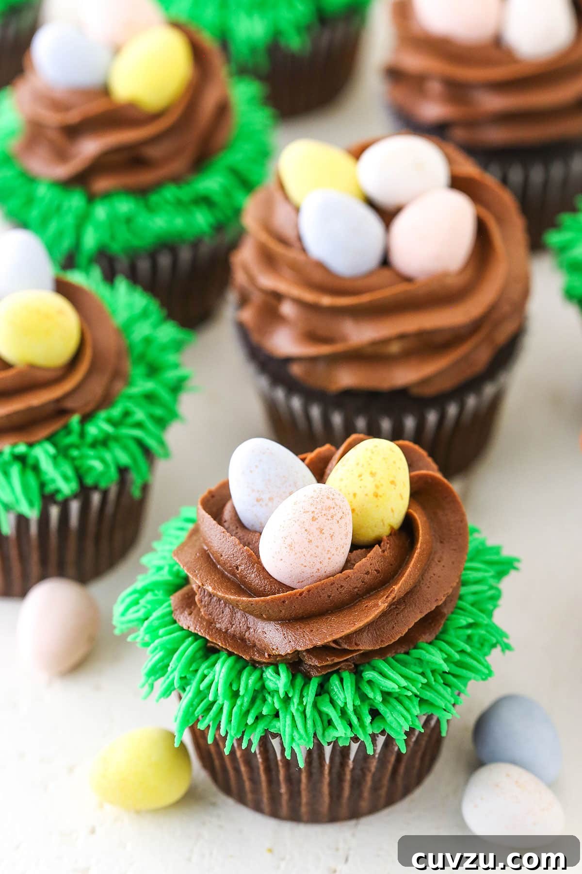 Festive Easter Egg Chocolate Cupcakes on White Beautifully presented Easter Egg Chocolate Cupcakes on a clean white tabletop, ready to be enjoyed.