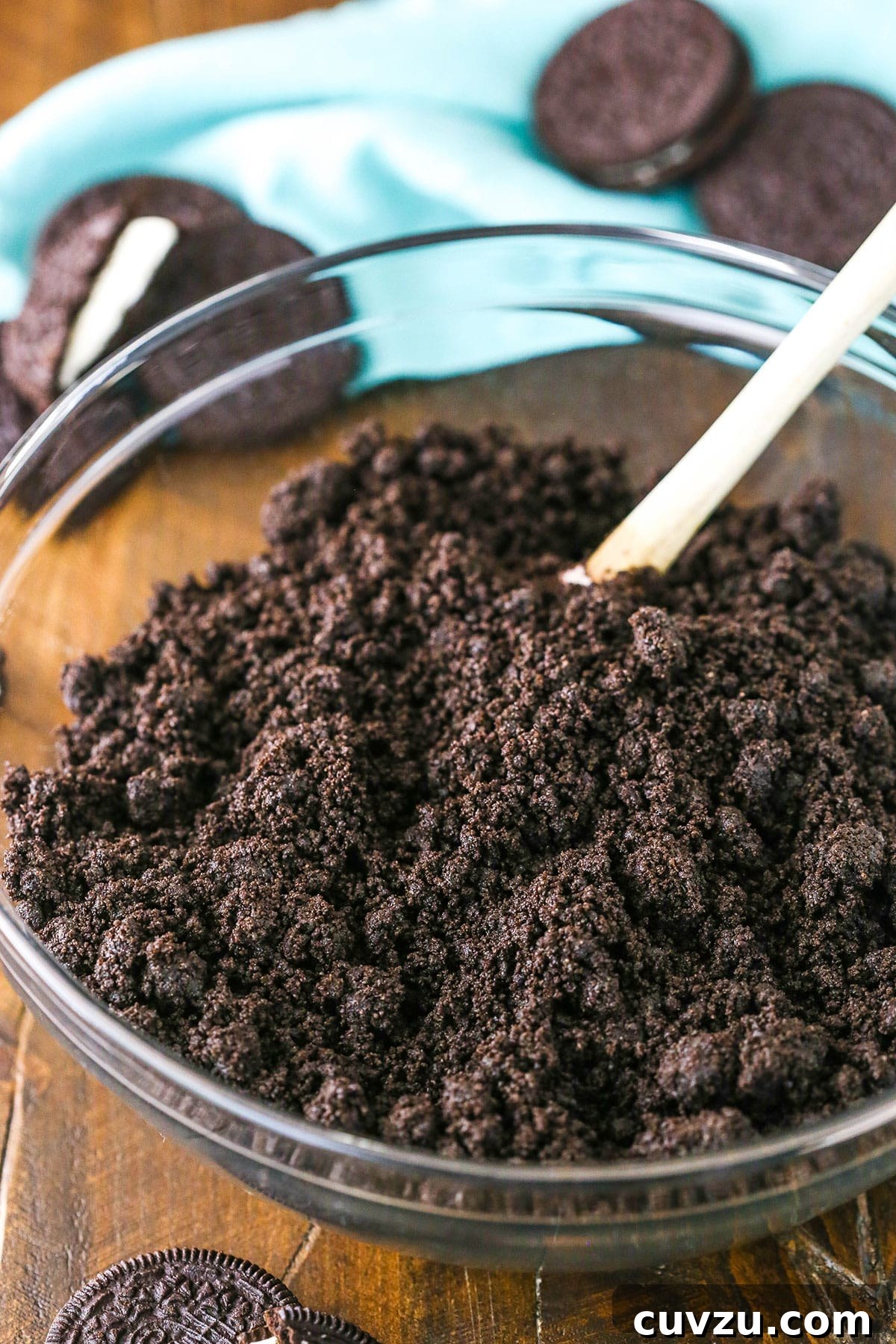 Effortless Oreo Pie Crust 4 A glass bowl filled with Oreo Cookies turned into fine crumbs using a food processor