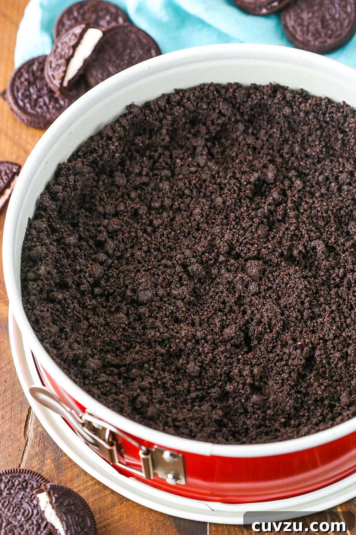 Effortless Oreo Pie Crust 5 A step in making Oreo Cookie Crust showing the crust mixture in a springform pan