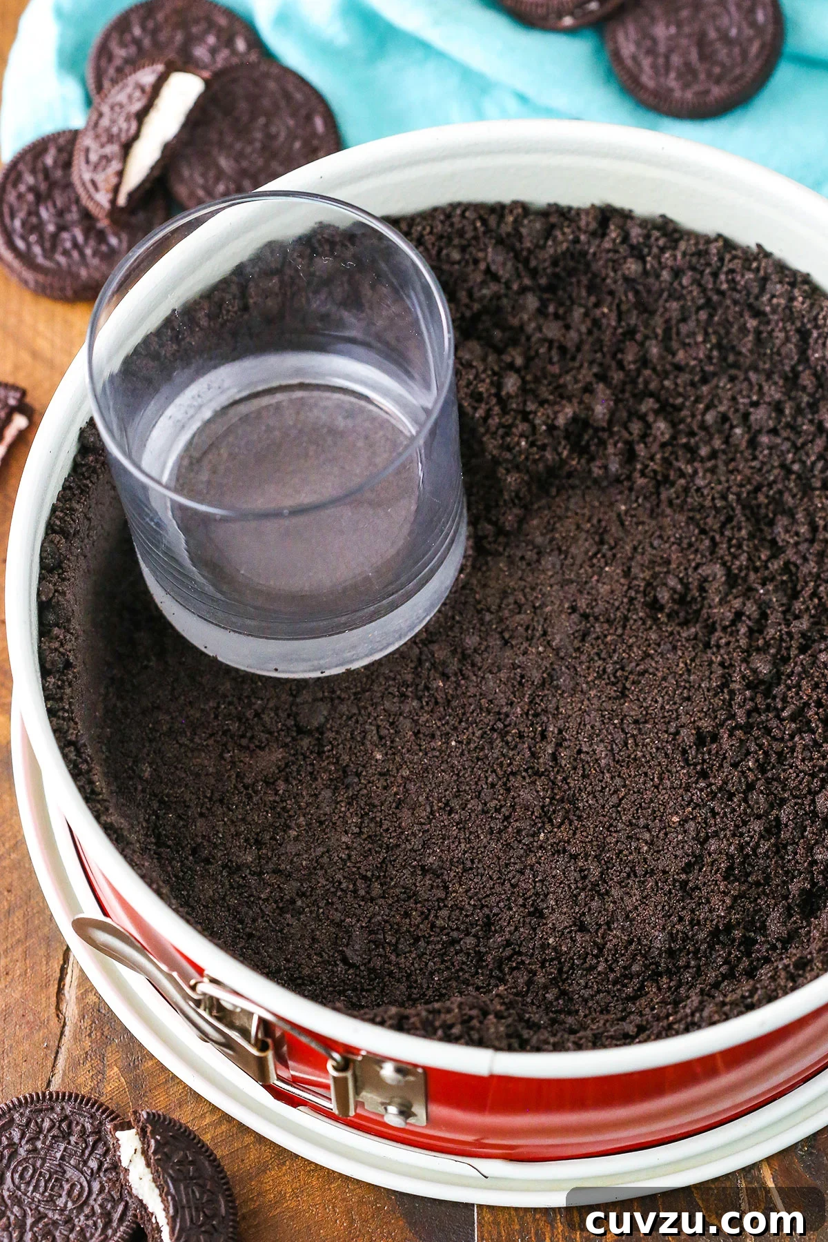 Effortless Oreo Pie Crust 6 A step in making Oreo Cookie Crust showing the crust mixture pressed into the bottom and up the sides of a springform pan