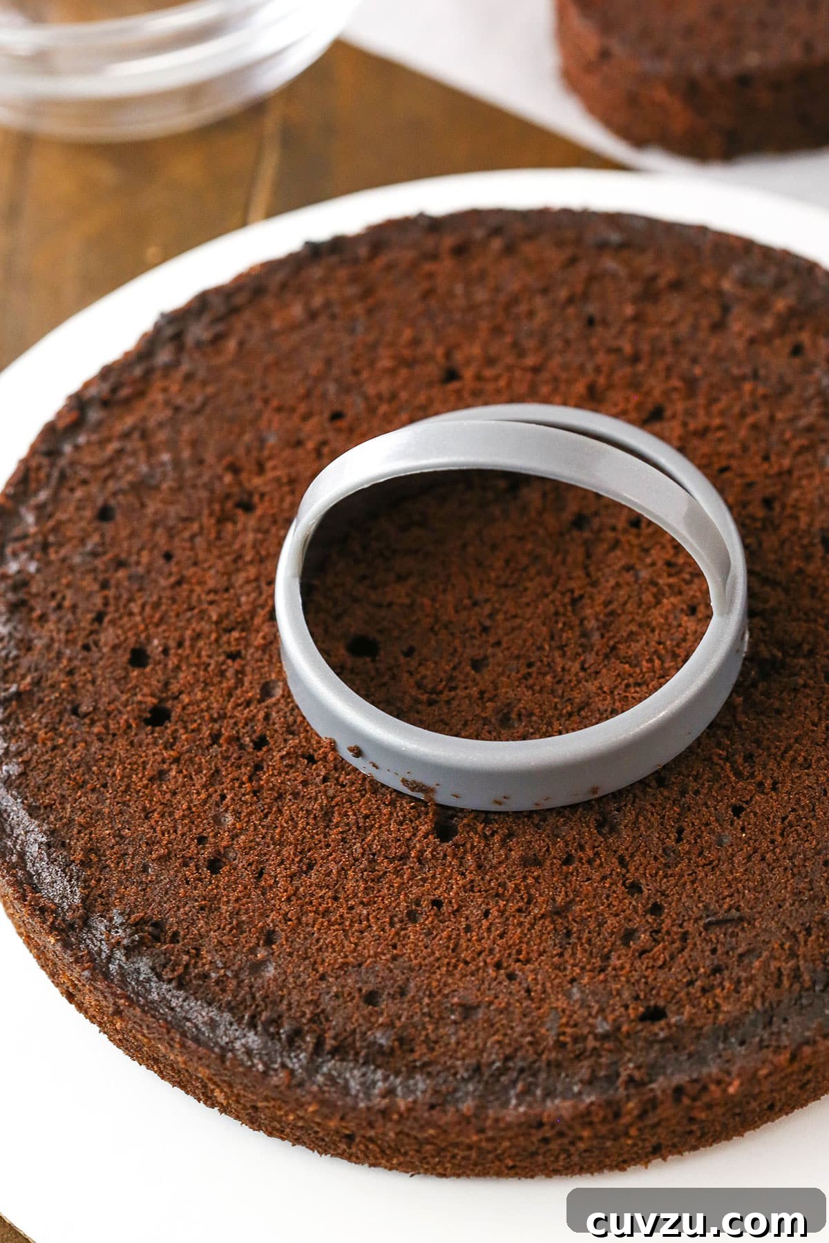 Candy Burst Chocolate Confection 5 A step in making Chocolate Piñata Cake using a biscuit cutter to make a hole in the middle of each layer.