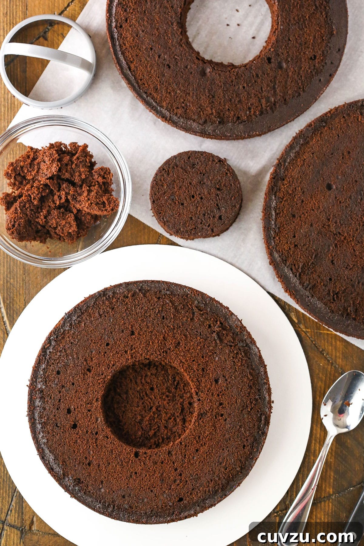 Candy Burst Chocolate Confection 7 A step in making Chocolate Piñata Cake, showing a partially cut hole in the bottom layer.