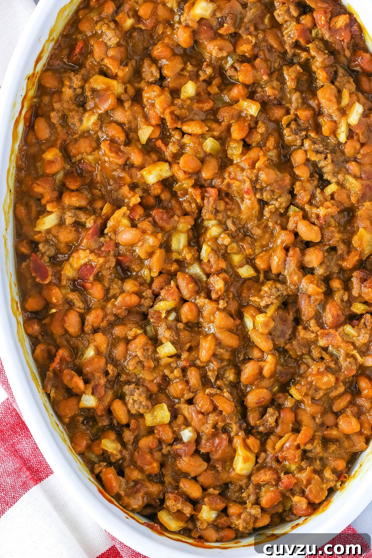Mom's Legendary Baked Beans 4 An overhead view of Mom's Amazing Baked Beans served in a pristine white dish, showcasing their rich color and inviting texture, ready to be enjoyed.