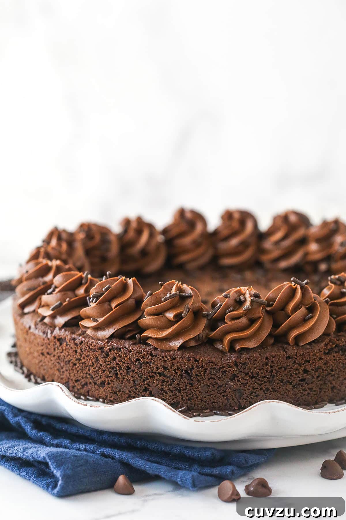 Our complete Triple Chocolate Cookie Cake, ready for serving. The entire triple chocolate cookie cake, beautifully frosted and presented on an elegant serving platter, ready for guests.