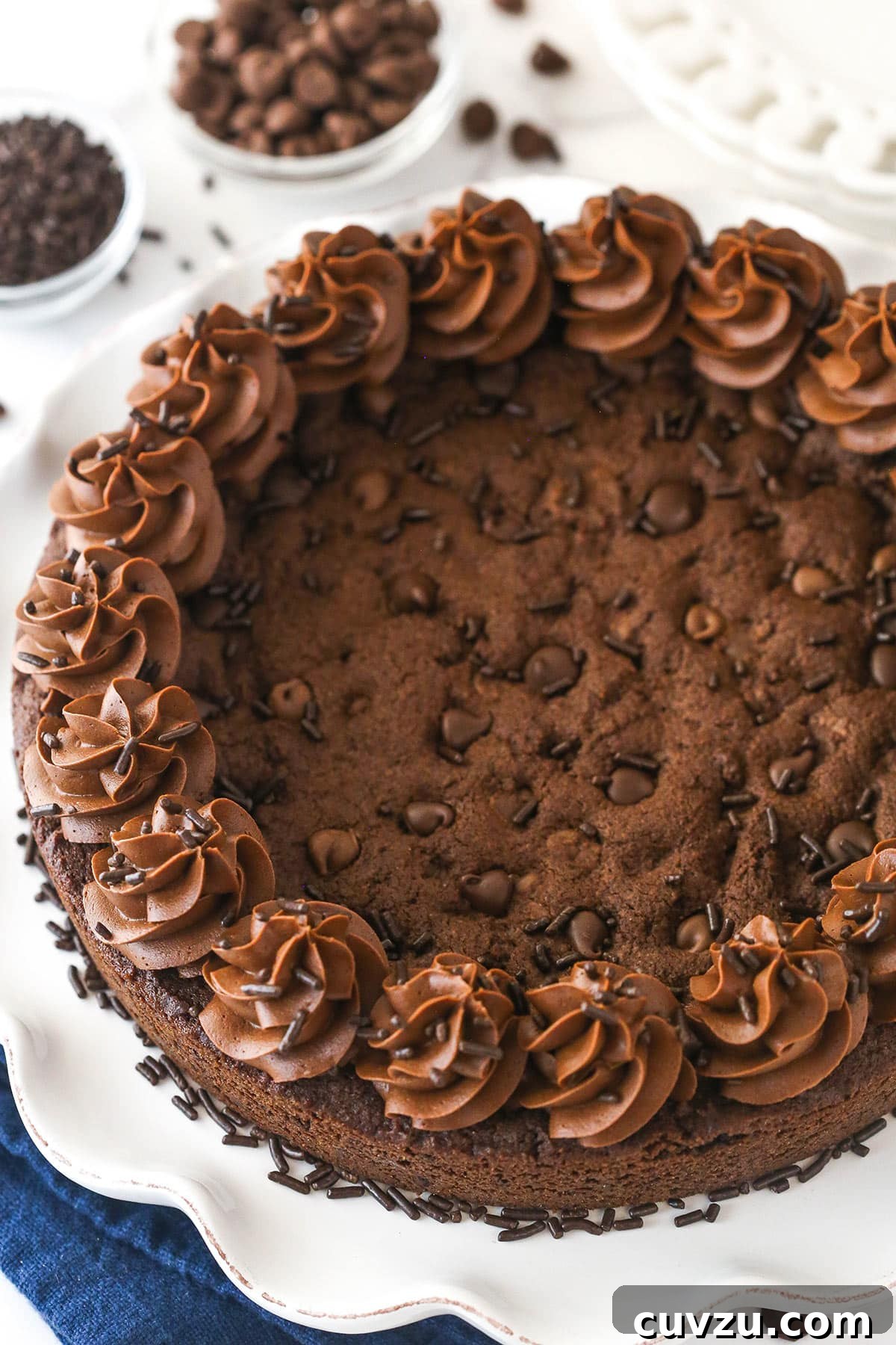 Our exquisite Triple Chocolate Cookie Cake, perfect for sharing. An inviting overhead shot of the decorated triple chocolate cookie cake, presented beautifully on a serving platter, ready for slicing.