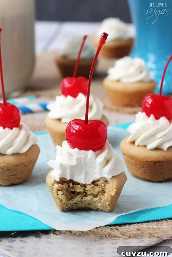 Old-Fashioned Root Beer Float Bites 5 A Root Beer Float Cookie Cup with a bite taken out, revealing the soft interior of the cookie and the creamy whipped topping.