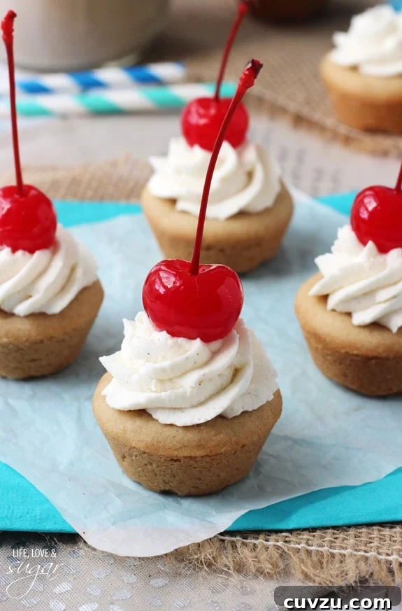 Old-Fashioned Root Beer Float Bites 7 Close-up of a Root Beer Float Cookie Cup, garnished with a bright red maraschino cherry and a delicate swirl of whipped cream.