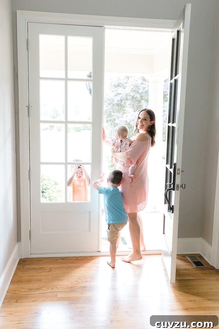 McKenzie's Seven-Month Adventure 12 Lindsay walking through an open front door with her three smiling children