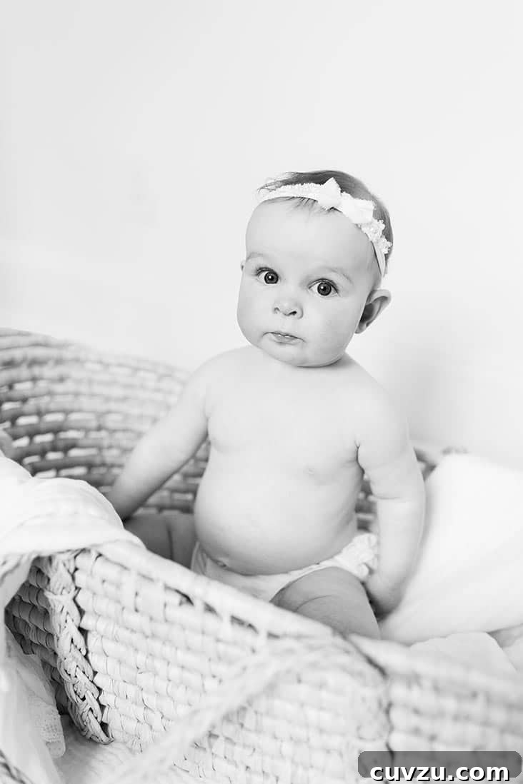 McKenzie's Seven-Month Adventure 3 Black and white photo of 7-month-old McKenzie sitting cheerfully in a basket