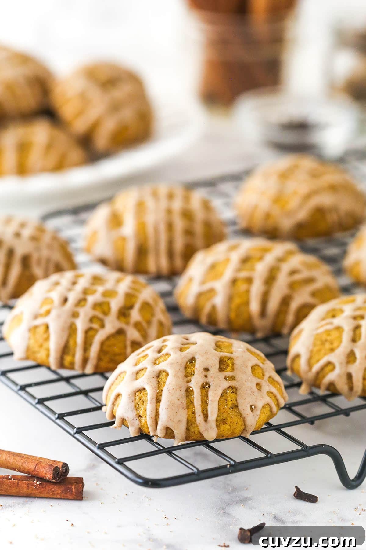 Pillowy Pumpkin Delights 11 Freshly baked pumpkin cookies arranged on a cooling rack.