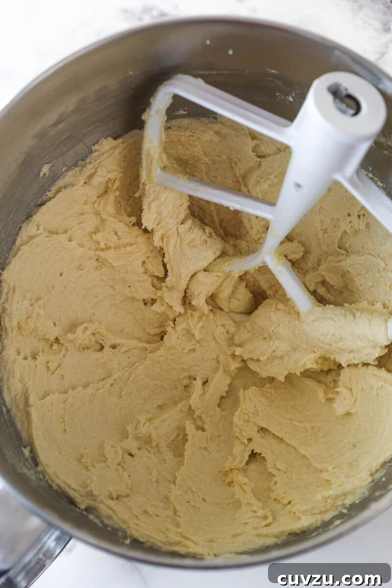 Pillowy Pumpkin Delights 5 Creaming the butter and sugars together in a mixing bowl.