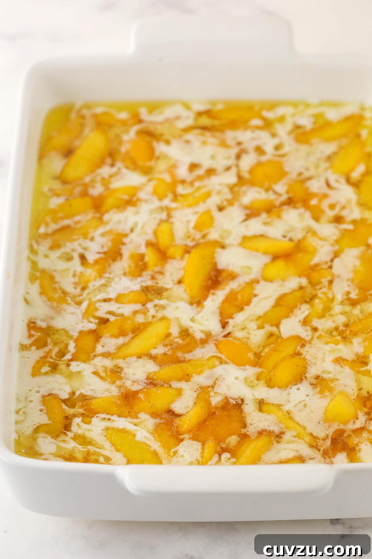 No-Fuss Peach Cobbler Delight 3 melted butter, batter and peaches all added to the casserole pan