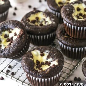 Decadent Black Bottom Cupcakes Recipe — Easy, Gooey Chocolate Centers 7 Black bottom cupcakes stacked on a wire rack