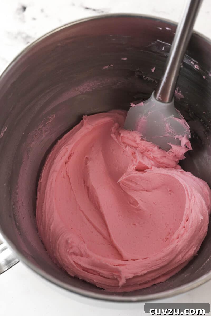 Prepare frosting Pink buttercream frosting in a bowl