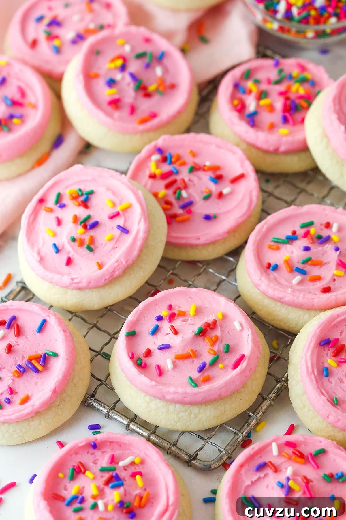 These copycat Lofthouse Cookies are soft and cakey with a melt-in-your-mouth texture and light flavor, just like the ones at the supermarket. Overhead view of copycat Lofthouse cookies on a wire rack