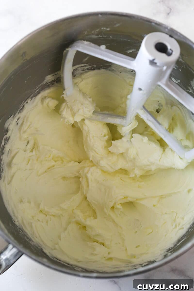 Cream butter and powdered sugar Creamed butter and powdered sugar in a mixing bowl