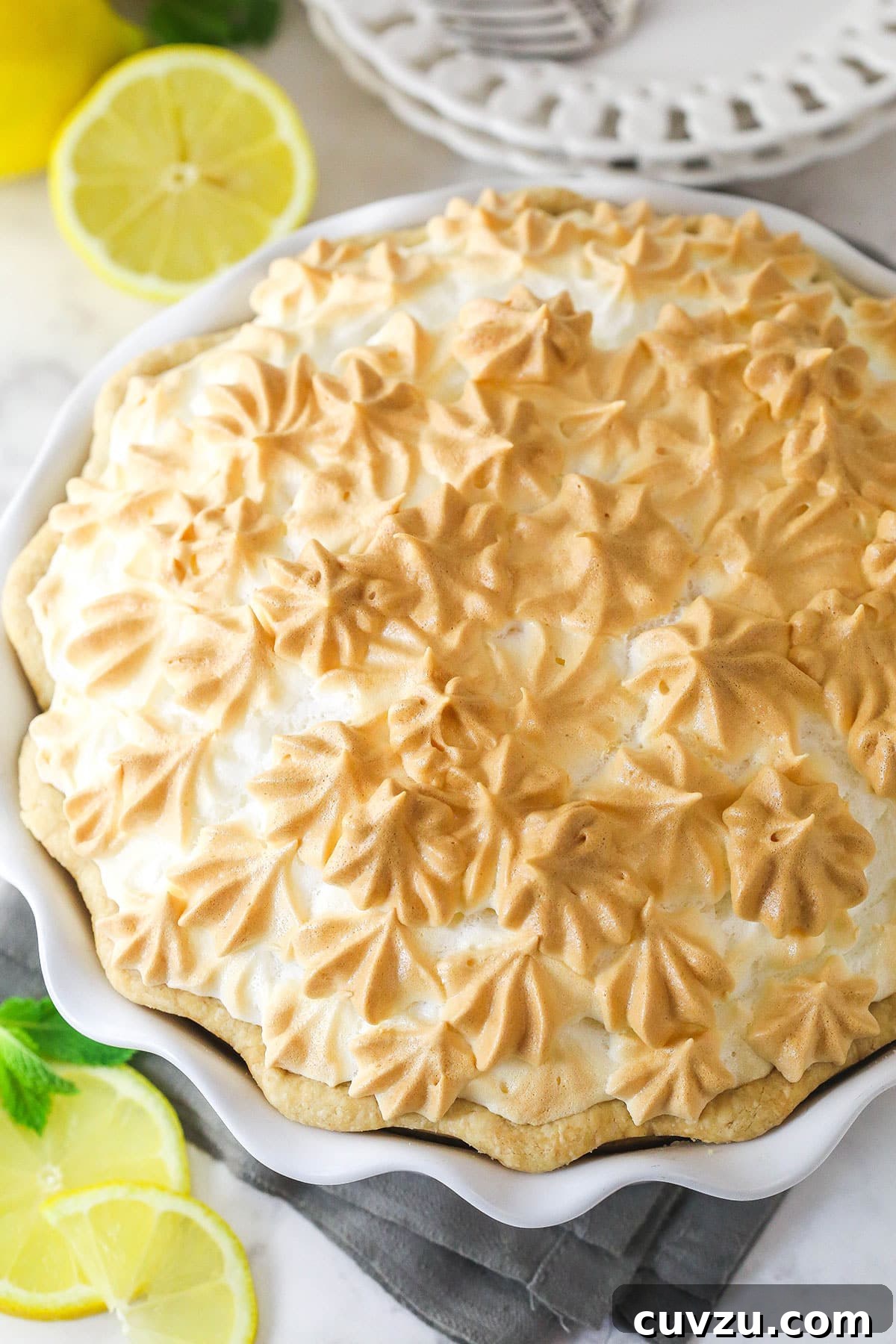 This classic lemon meringue pie features a tart lemon filling in a buttery crust topped with a light but stable meringue. Overhead view of a lemon meringue pie